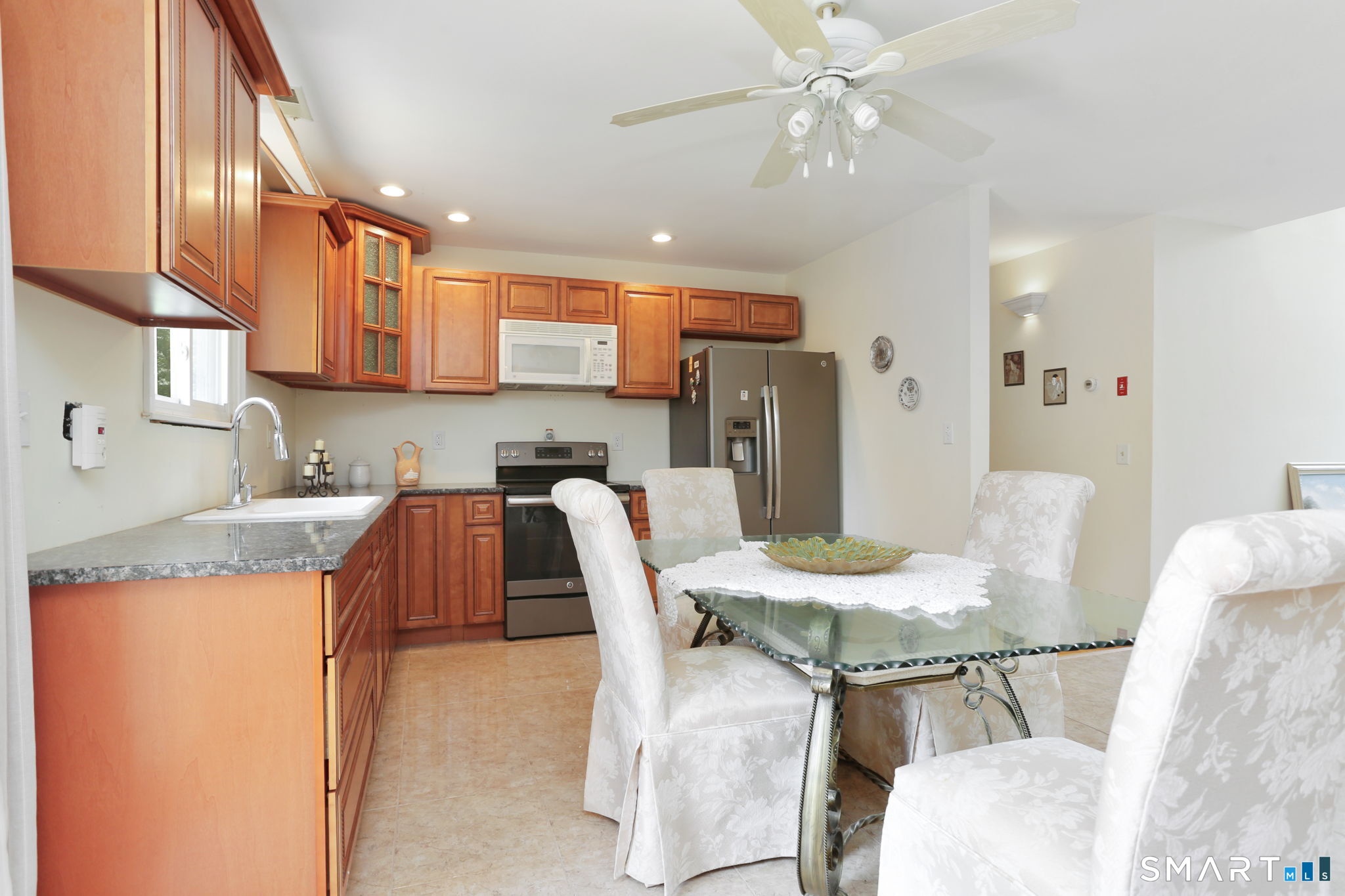 421 Strong Street East Haven, CT 06512 - Photo 15 of 30 a kitchen with refrigerator a sink and chairs