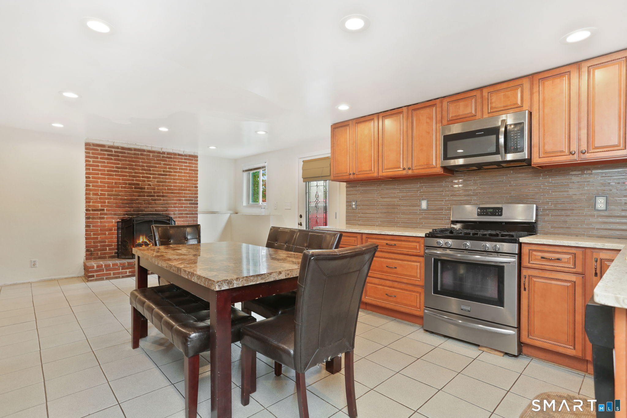 421 Strong Street East Haven, CT 06512 - Photo 19 of 30 a kitchen with stainless steel appliances a stove a sink a microwave a refrigerator and cabinets