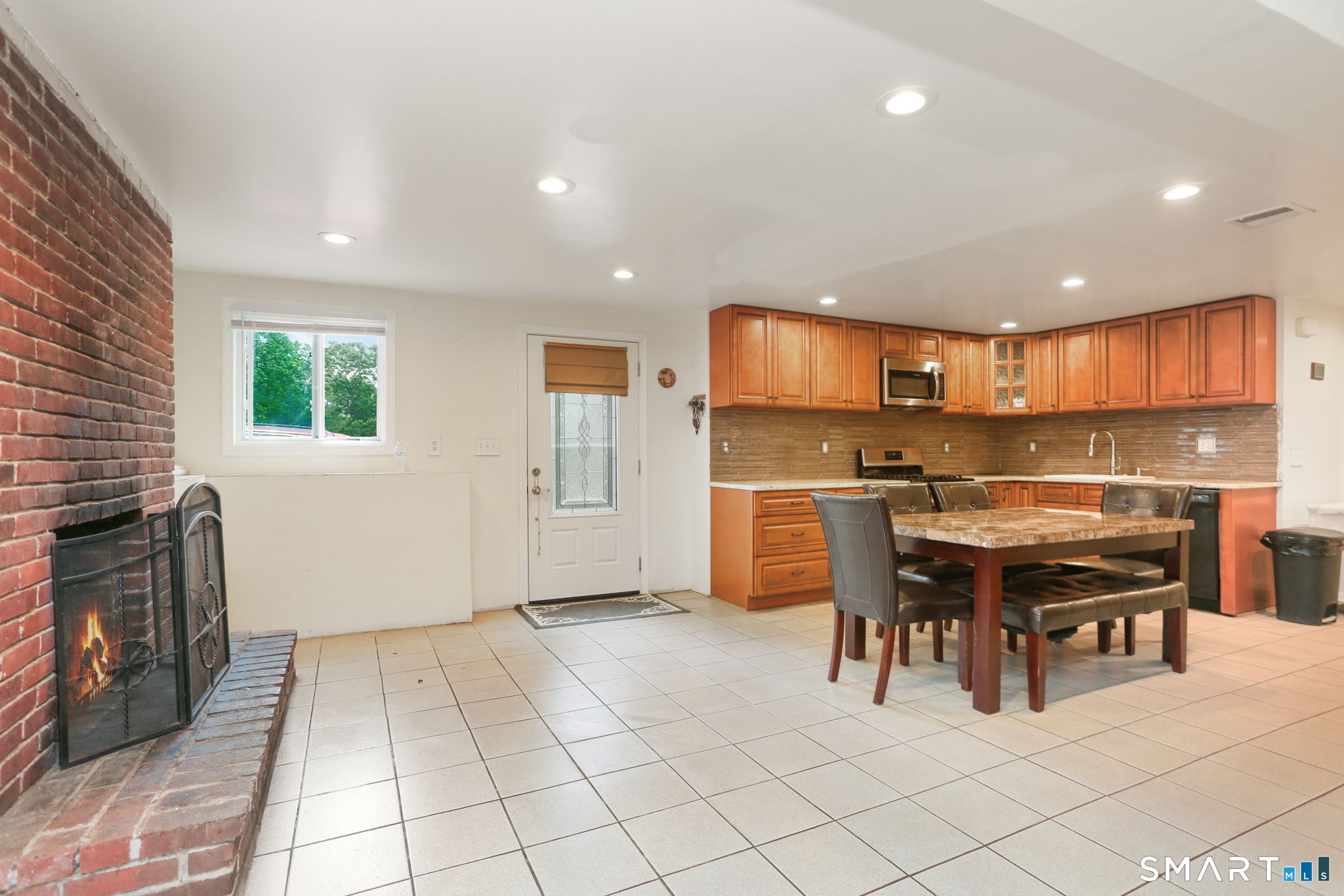 421 Strong Street East Haven, CT 06512 - Photo 23 of 30 a kitchen with stainless steel appliances kitchen island granite countertop a stove a sink a dining table and chairs