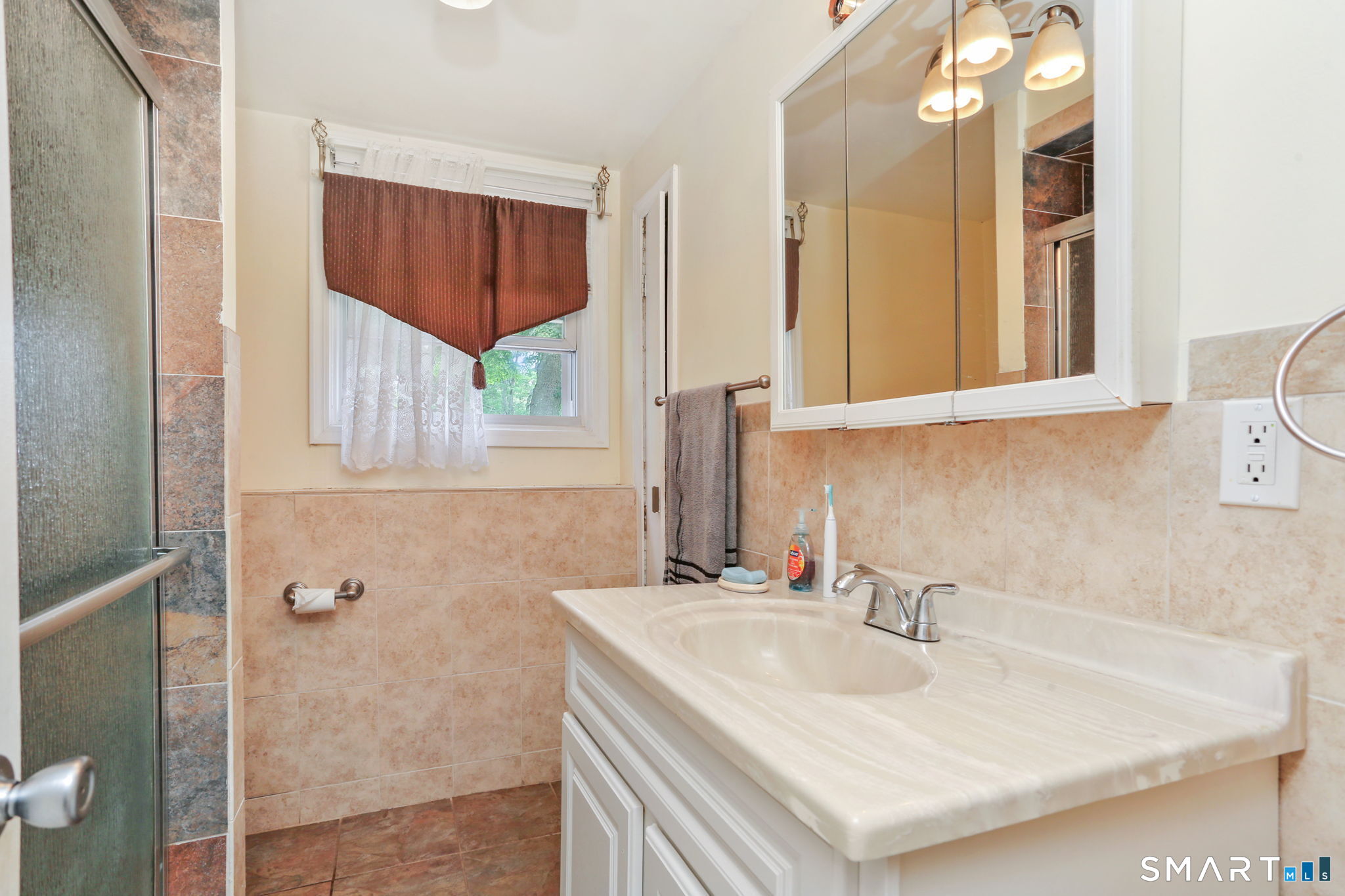 421 Strong Street East Haven, CT 06512 - Photo 24 of 30 a bathroom with a sink and a mirror
