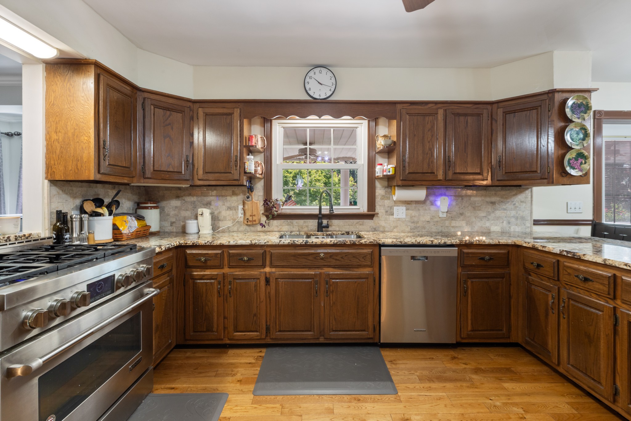 7422 Indian Creek Road McEwen, TN 37101 - Photo 26 of 71 a kitchen with stainless steel appliances granite countertop a stove a sink dishwasher and a microwave oven next to a large window