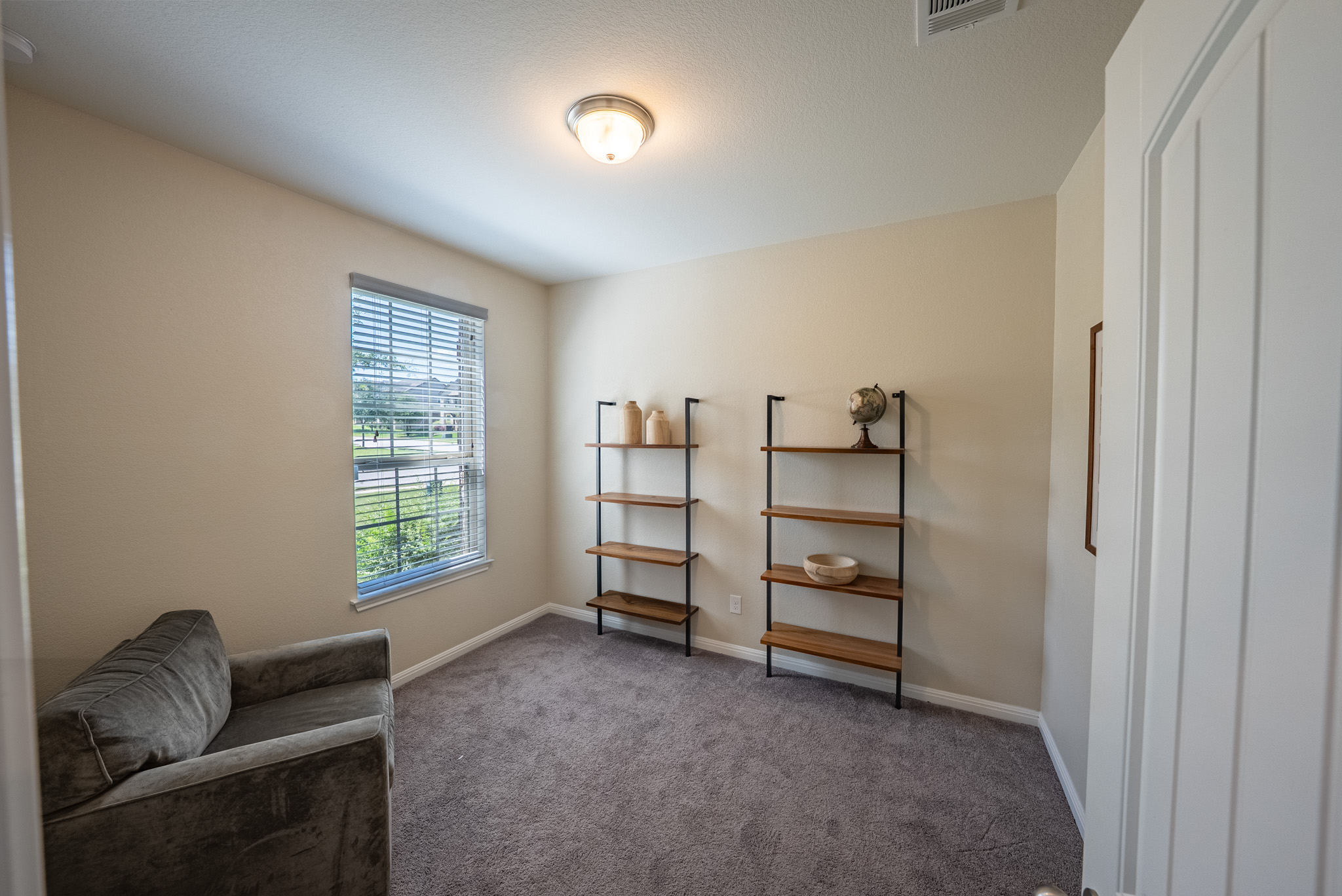 2508 Hat Bender Loop Round Rock, TX 78664 - Photo 17 of 22 Carpeted room with a single window featuring horizontal blinds
