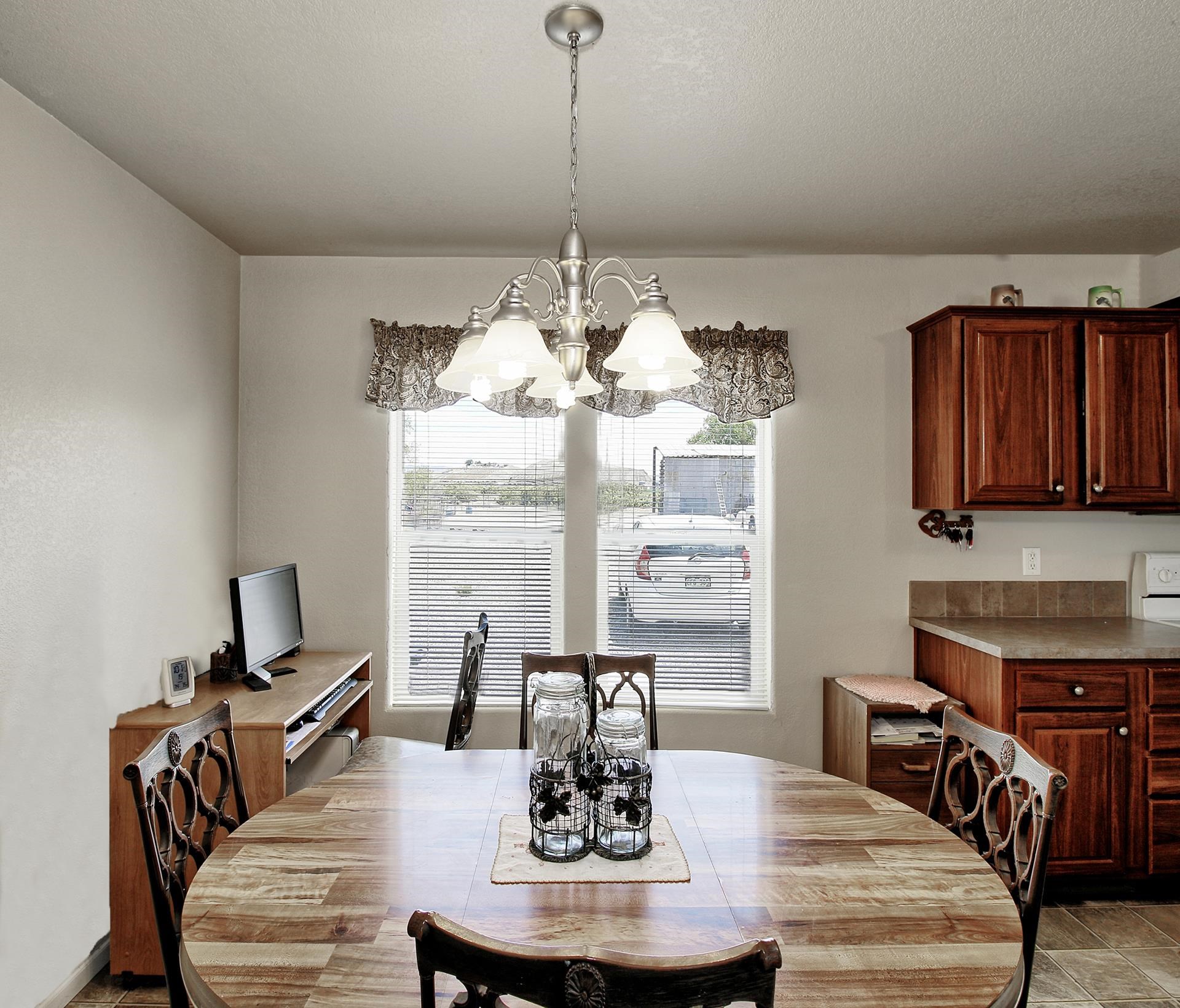 1548 18 Road Fruita, CO 81521 - Photo 29 of 34 a dining room with furniture a chandelier and wooden floor