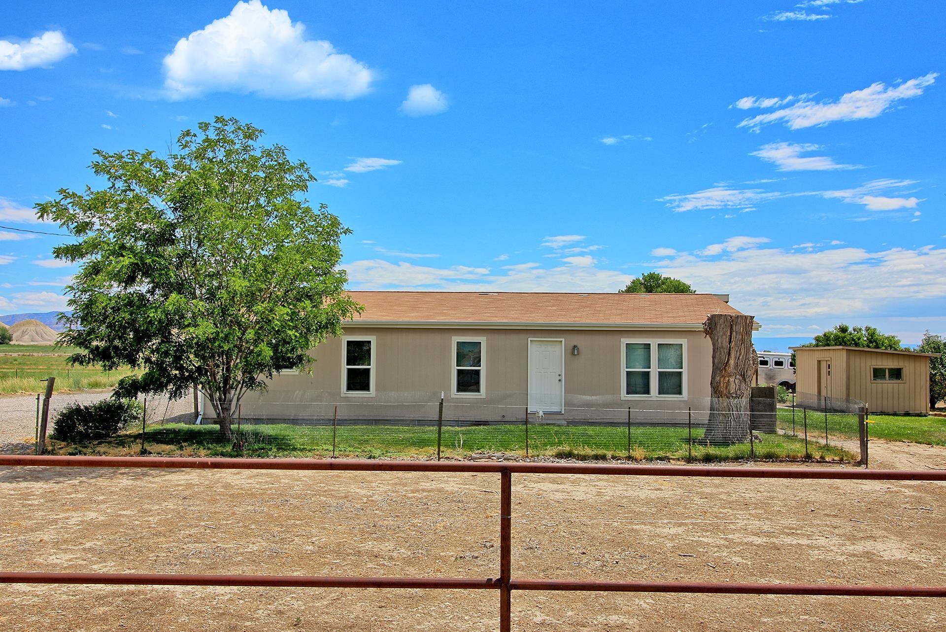 1548 18 Road Fruita, CO 81521 - Photo 4 of 34 front view of a house with a street