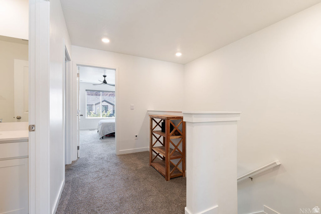 1693 Devils Gdn Lane Washington, UT 84780 - Photo 19 of 64 Upper-level hallway with plush gray carpeting, recessed lighting, white trim, and a white balustrade