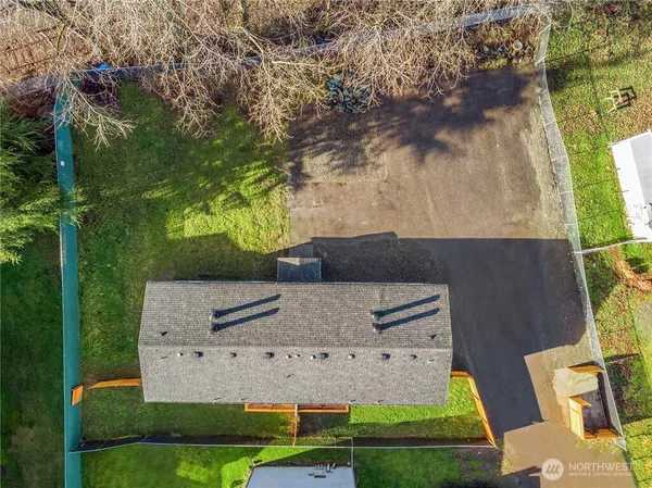an aerial view of a house with garden space and street view