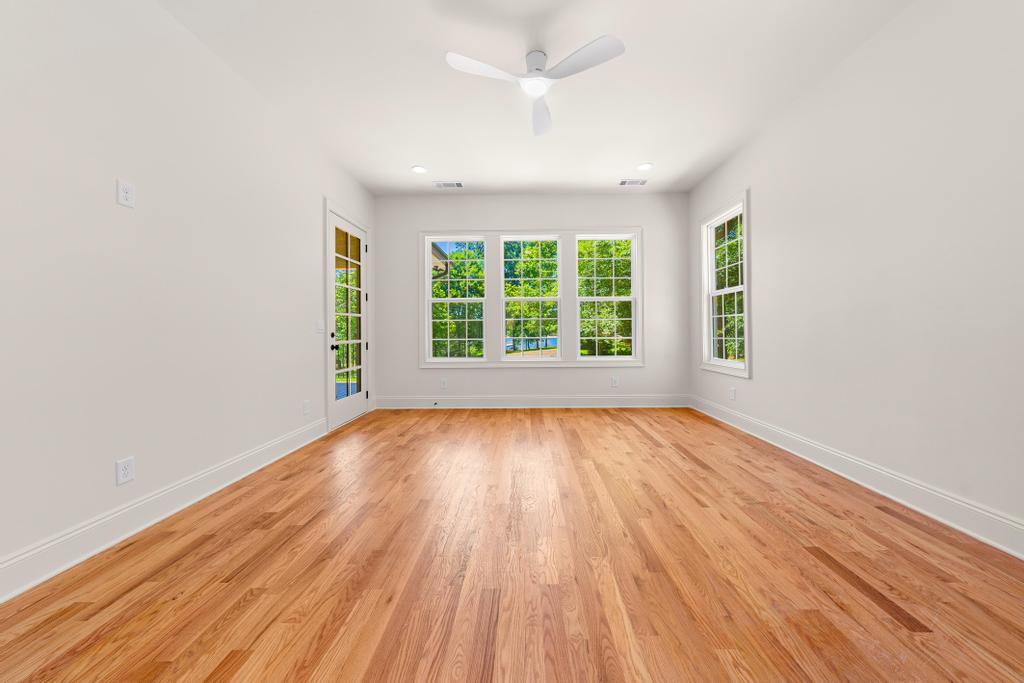 707 Vickery Street Extension Hartwell, GA 30643 - Photo 18 of 50 Natural light floods this versatile space, highlighting the rich hardwood flooring and lush outdoor views.
