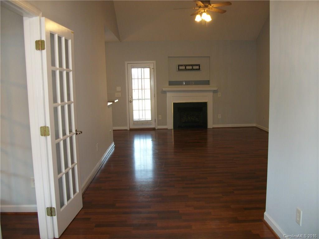 2118 Doster Road, Unit 1 Monroe, NC 28112 - Photo 3 of 24 a view of a hallway with wooden floor a fireplace and windows