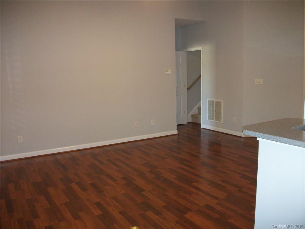 2118 Doster Road, Unit 1 Monroe, NC 28112 - Photo 7 of 24 a view of an empty room with wooden floor and a window