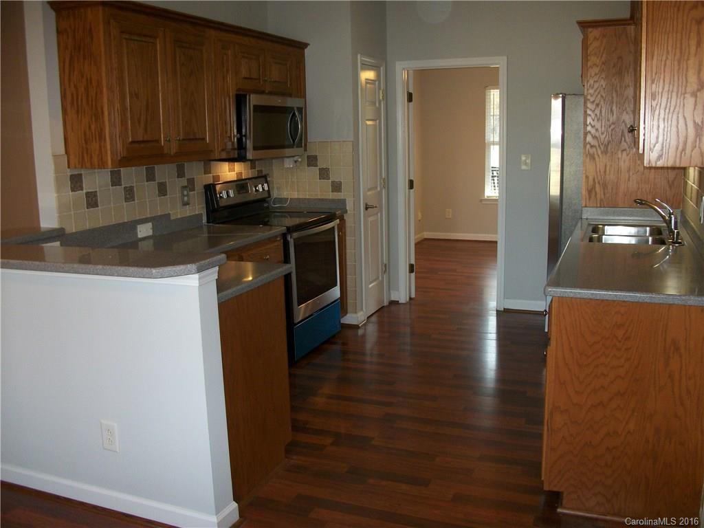2118 Doster Road, Unit 1 Monroe, NC 28112 - Photo 8 of 24 a kitchen with granite countertop a sink stove and refrigerator