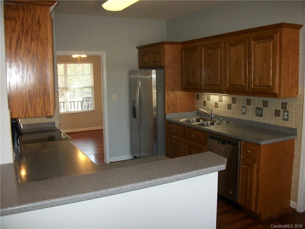 2118 Doster Road, Unit 1 Monroe, NC 28112 - Photo 9 of 24 a kitchen that has a sink and a stove
