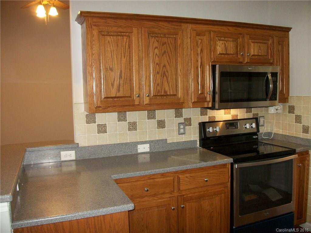 2118 Doster Road, Unit 1 Monroe, NC 28112 - Photo 10 of 24 a kitchen with granite countertop a stove top oven cabinetry a sink and dishwasher