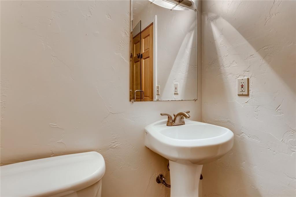 27 Rasor Court Keystone, CO 80435 - Photo 11 of 30 a bathroom with a sink a toilet and mirror