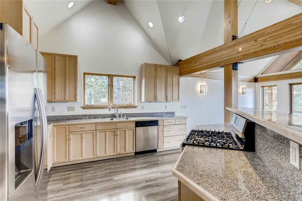 27 Rasor Court Keystone, CO 80435 - Photo 3 of 30 a kitchen with stainless steel appliances granite countertop a stove a sink and a refrigerator