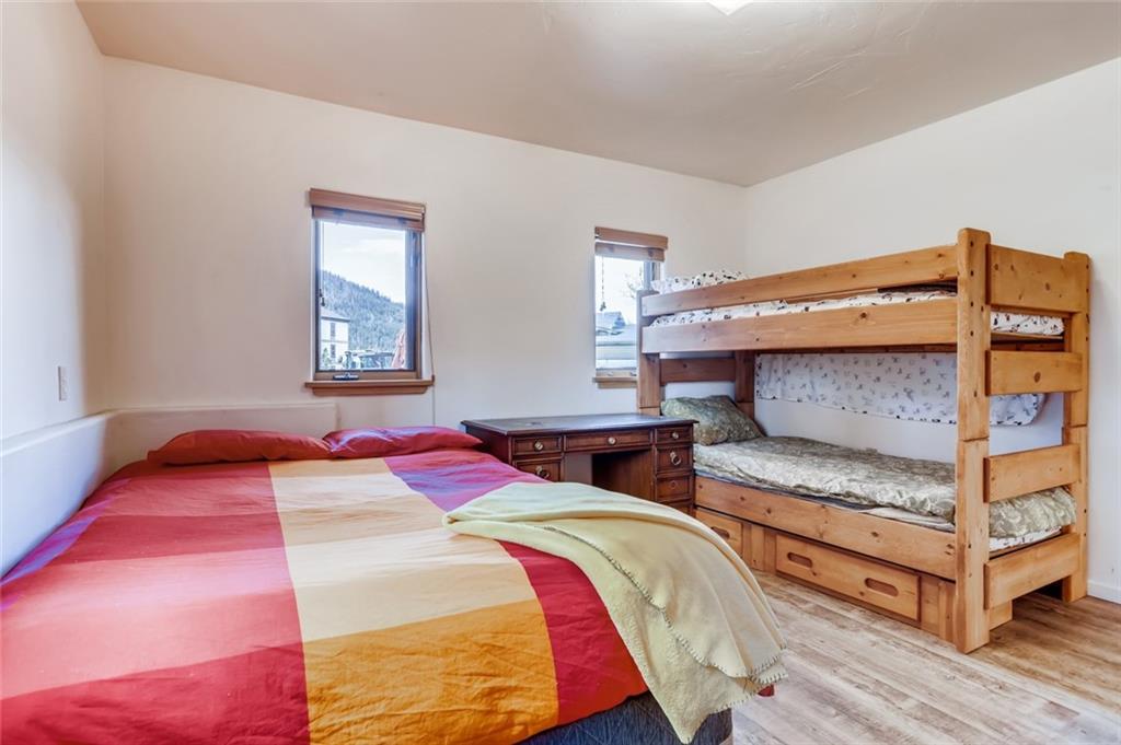 27 Rasor Court Keystone, CO 80435 - Photo 23 of 30 a bedroom with a bed and wooden floor