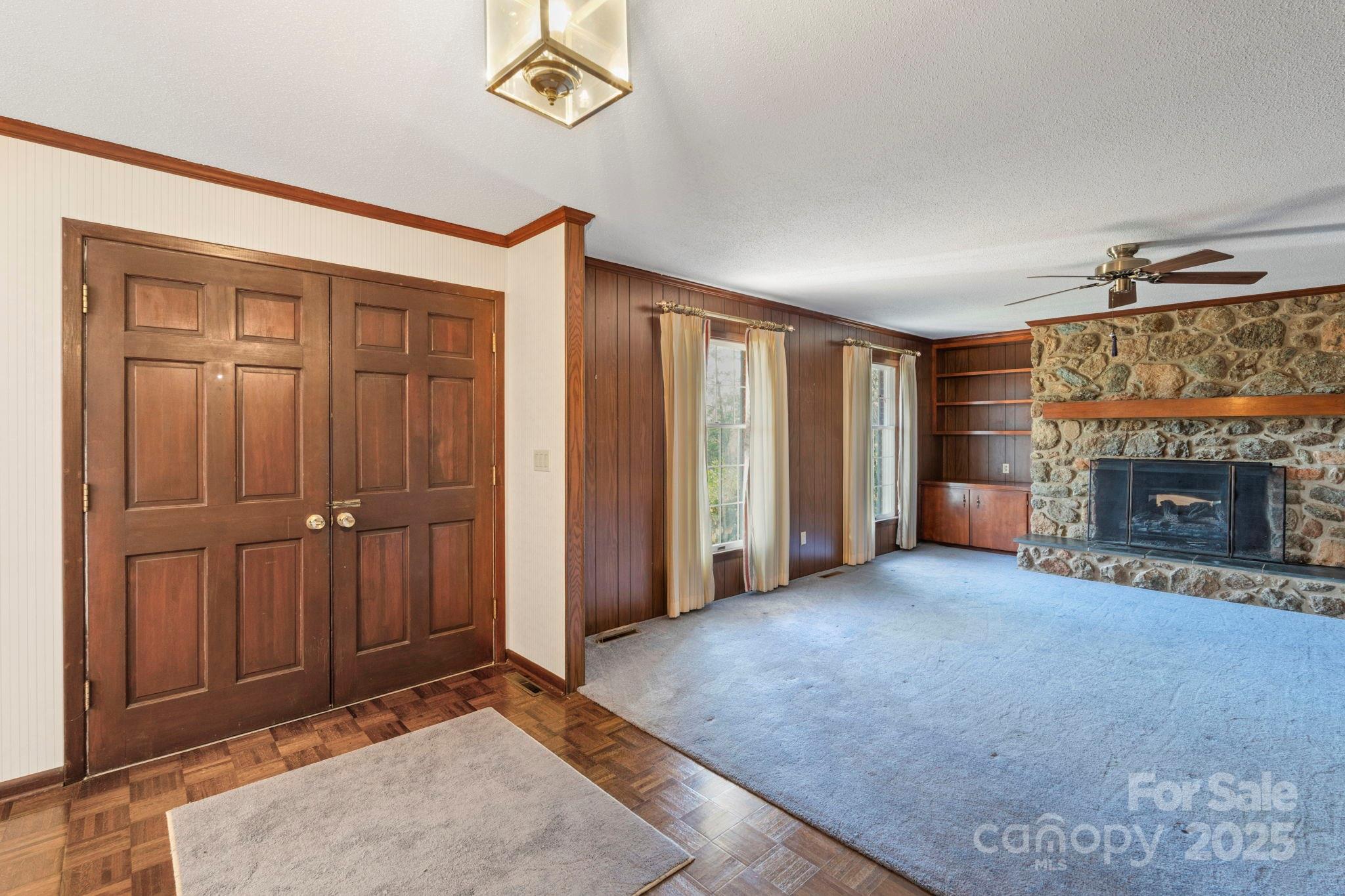 44372 Vickers Store Road Albemarle, NC 28001 - Photo 34 of 42 an empty room with windows and a fireplace