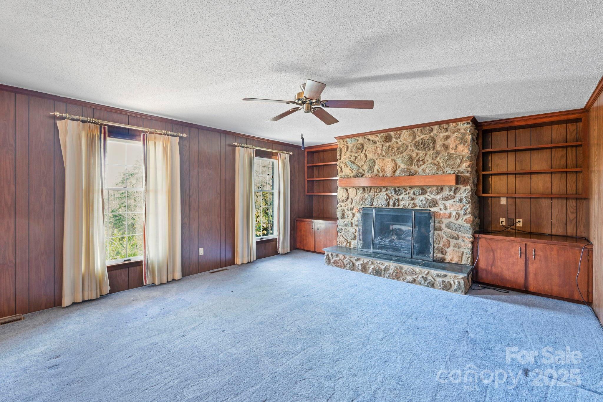 44372 Vickers Store Road Albemarle, NC 28001 - Photo 35 of 42 an empty room with furniture and a fireplace