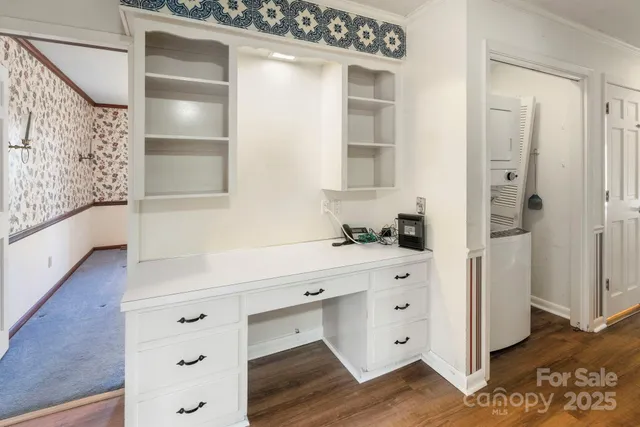 a view of cabinets a wooden floor and a window in the kitchen