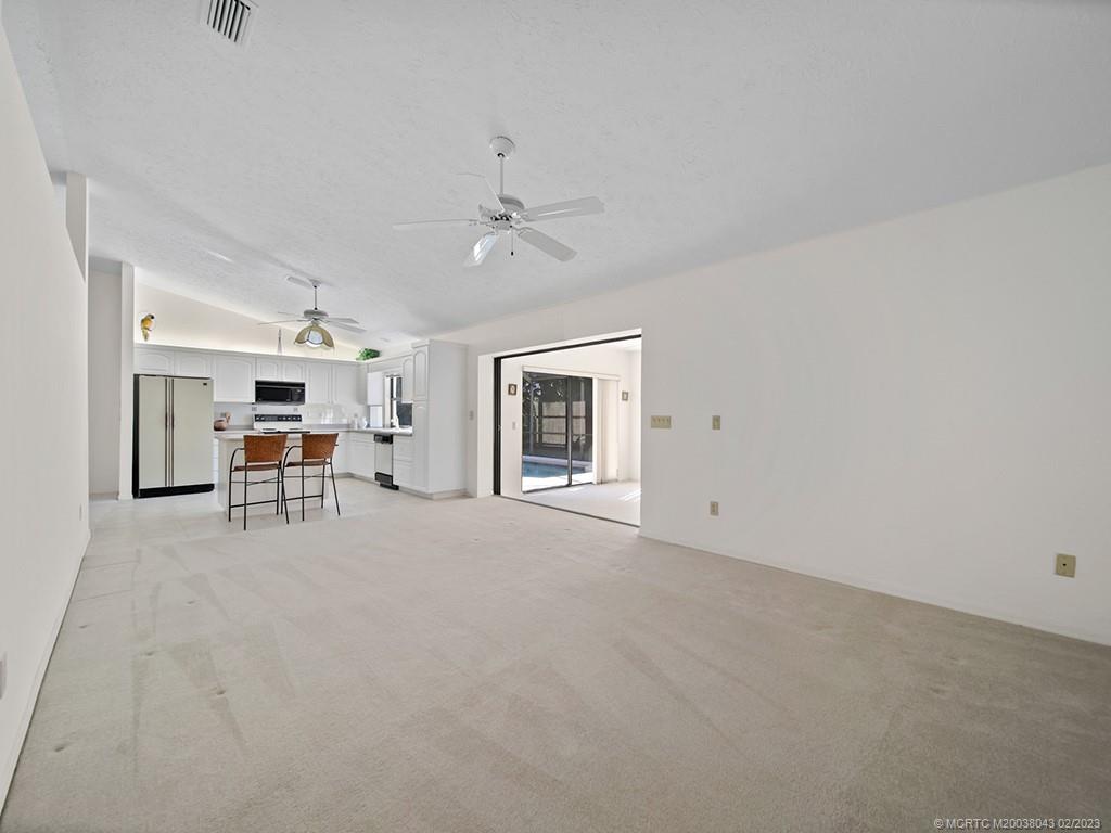 5 Copaire Road Stuart, FL 34996 - Photo 11 of 26 a view of a livingroom with furniture and a ceiling fan
