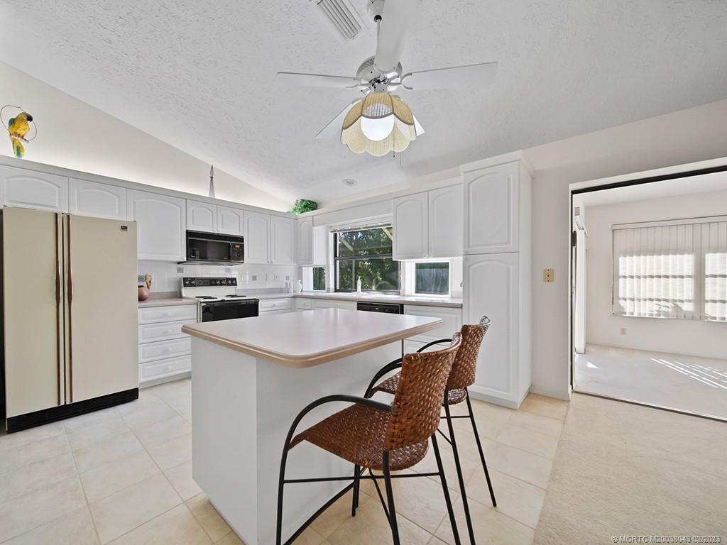 5 Copaire Road Stuart, FL 34996 - Photo 12 of 26 a view of a dining room with furniture window and wooden floor
