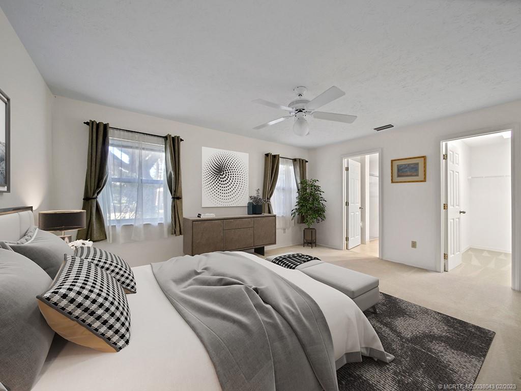 5 Copaire Road Stuart, FL 34996 - Photo 15 of 26 a bedroom with a bed couches and window