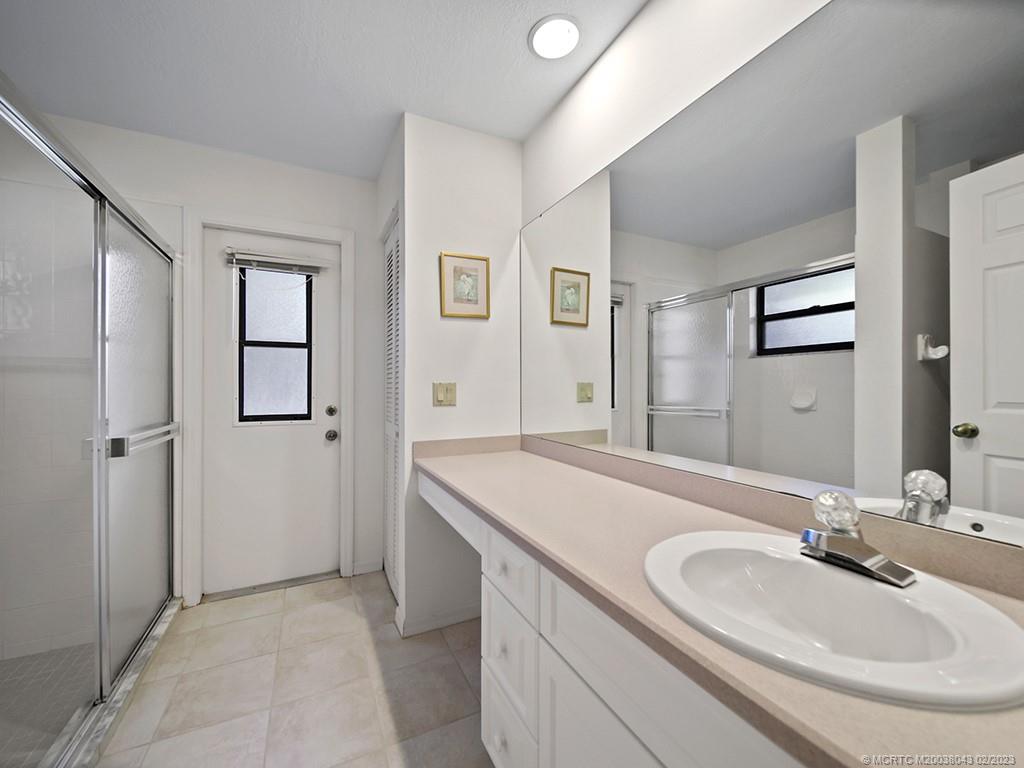 5 Copaire Road Stuart, FL 34996 - Photo 17 of 26 a bathroom with a sink and a mirror