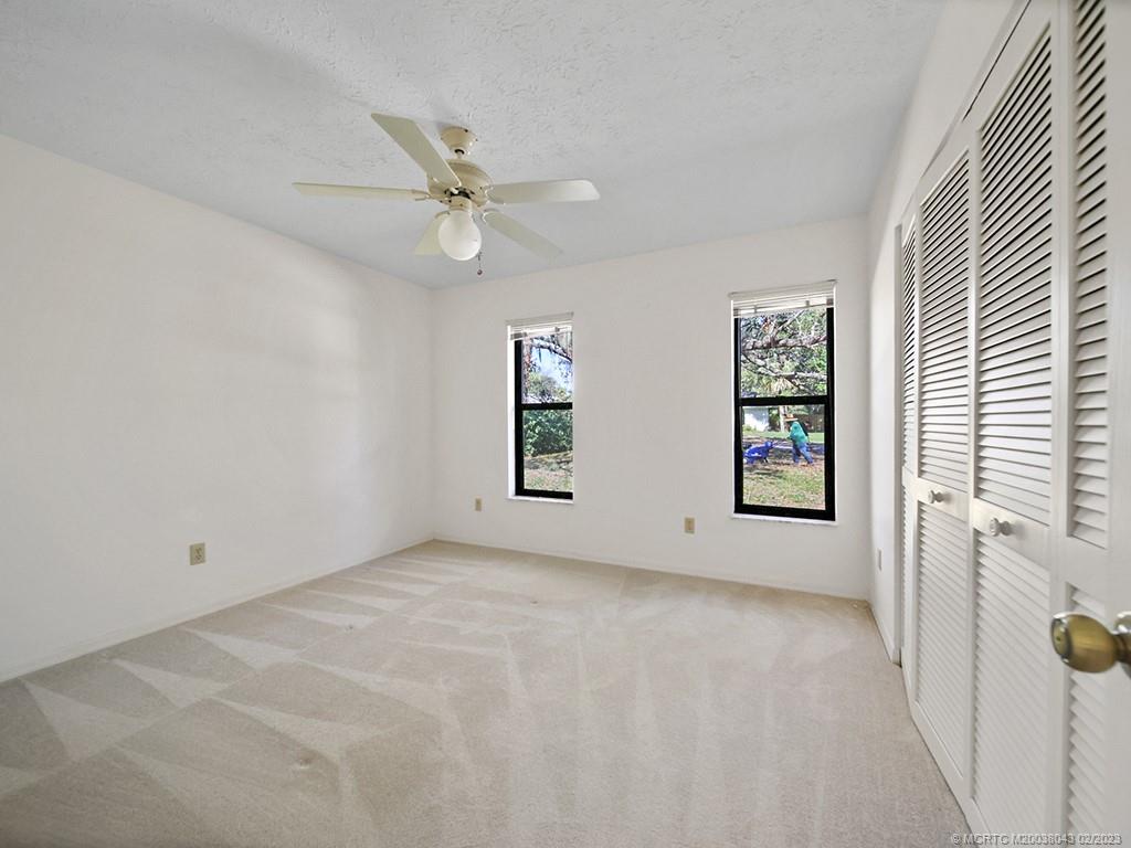 5 Copaire Road Stuart, FL 34996 - Photo 19 of 26 an empty room with windows and fan