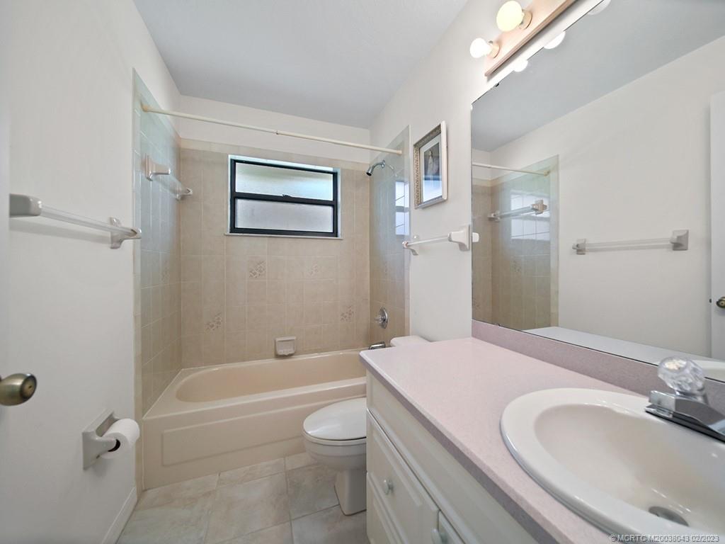 5 Copaire Road Stuart, FL 34996 - Photo 20 of 26 a bathroom with a sink a toilet and shower