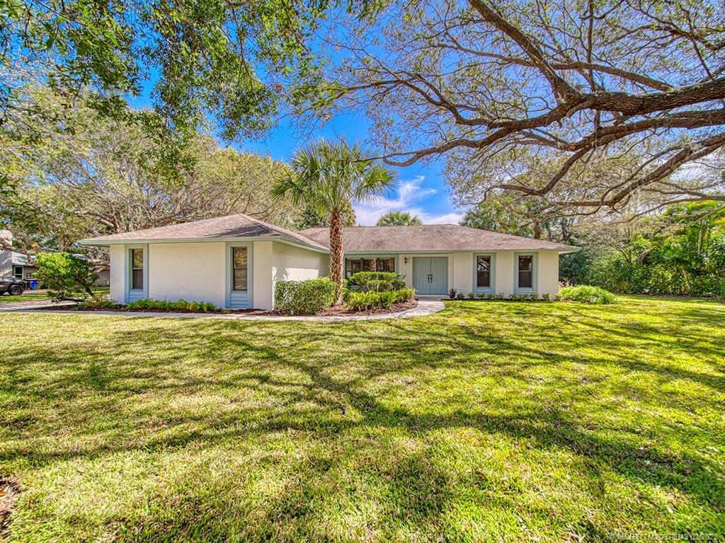 5 Copaire Road Stuart, FL 34996 - Photo 2 of 26 a front view of a house with a garden