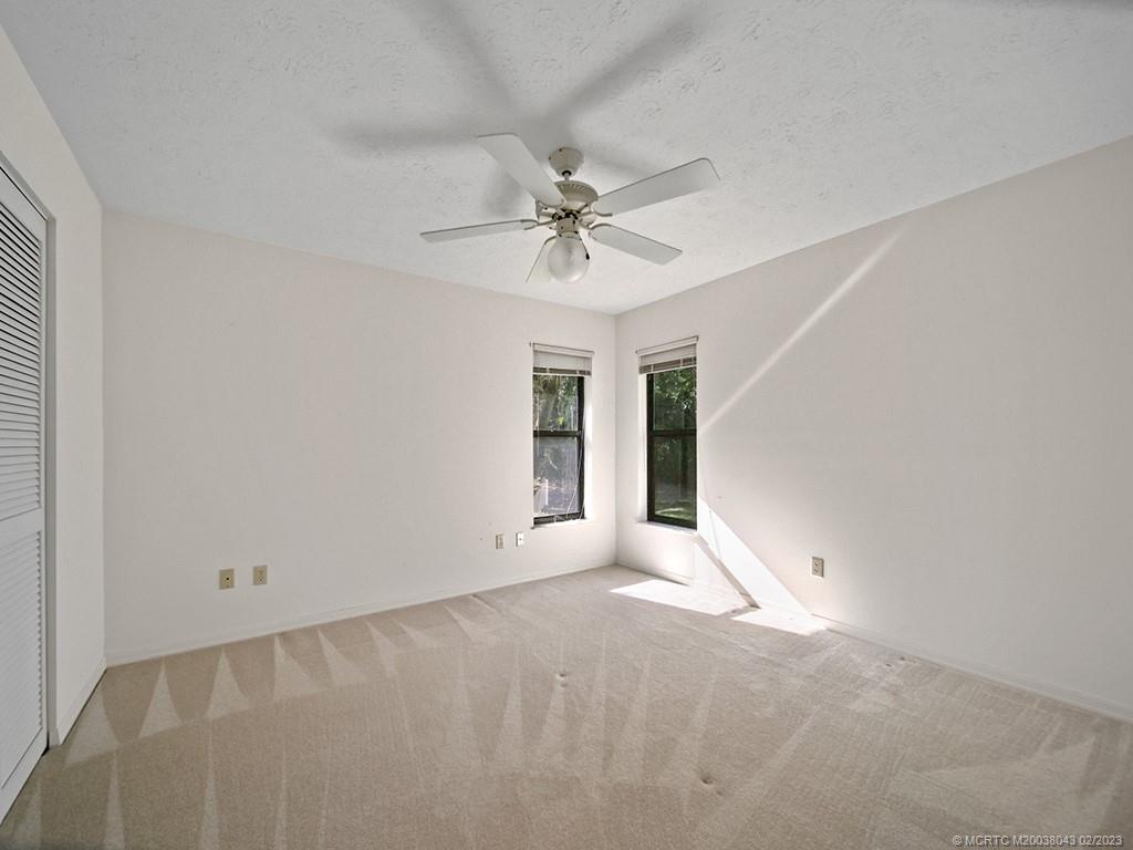 5 Copaire Road Stuart, FL 34996 - Photo 21 of 26 an empty room with a ceiling fan and a window