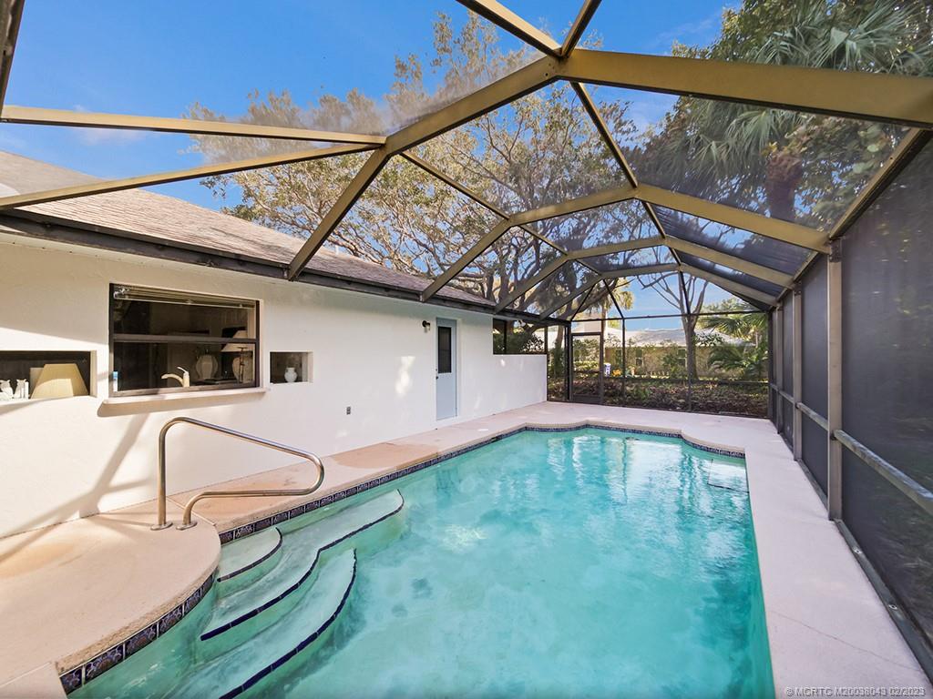 5 Copaire Road Stuart, FL 34996 - Photo 26 of 26 a view of a swimming pool with a patio and a yard