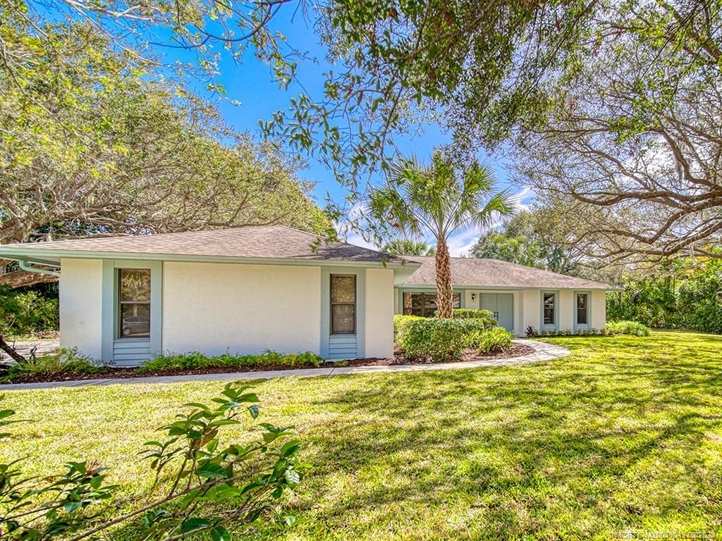 5 Copaire Road Stuart, FL 34996 - Photo 4 of 26 a front view of house with yard and trees around