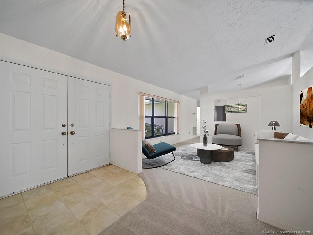 5 Copaire Road Stuart, FL 34996 - Photo 6 of 26 a living room with furniture and a window