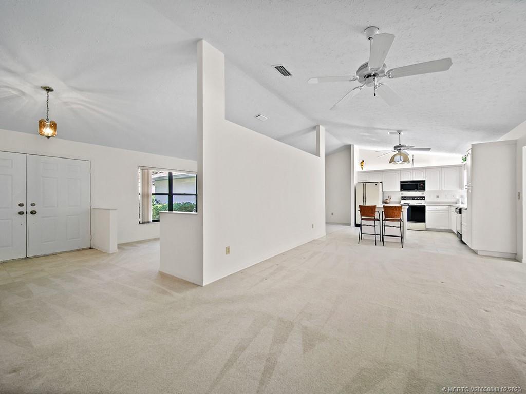 5 Copaire Road Stuart, FL 34996 - Photo 9 of 26 a view of a livingroom with furniture and a ceiling fan