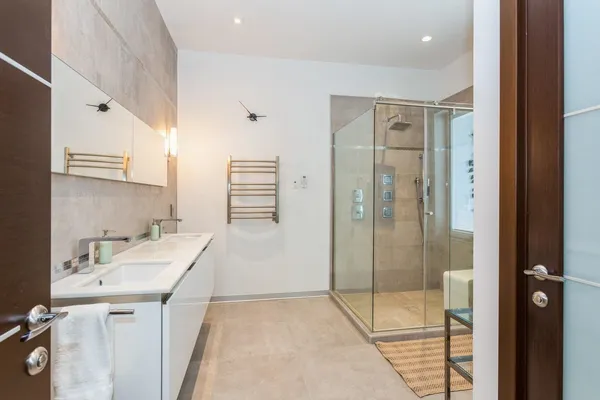 a bathroom with a sink and a mirror with shower