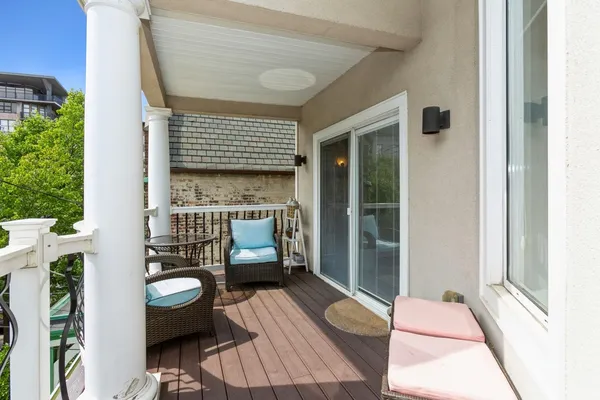 a balcony view with a couch and table potted plants