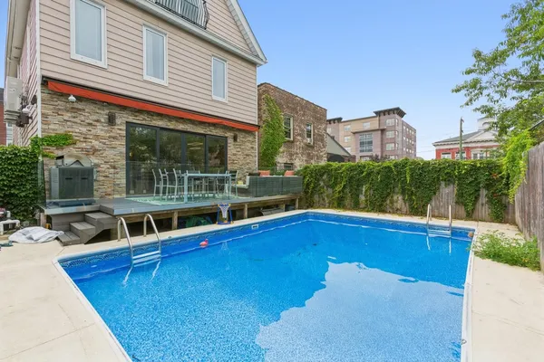 a view of a house with pool and a yard