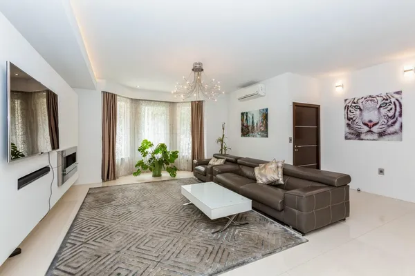 a living room with furniture and a flat screen tv
