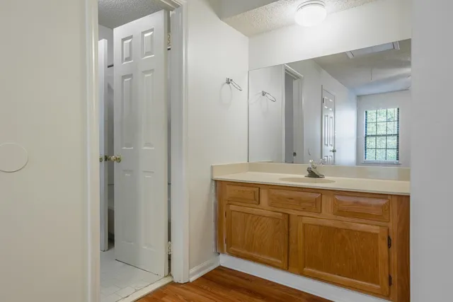 a bathroom with a granite countertop sink and a mirror