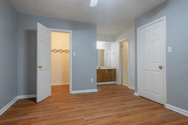 a view of empty room with wooden floor