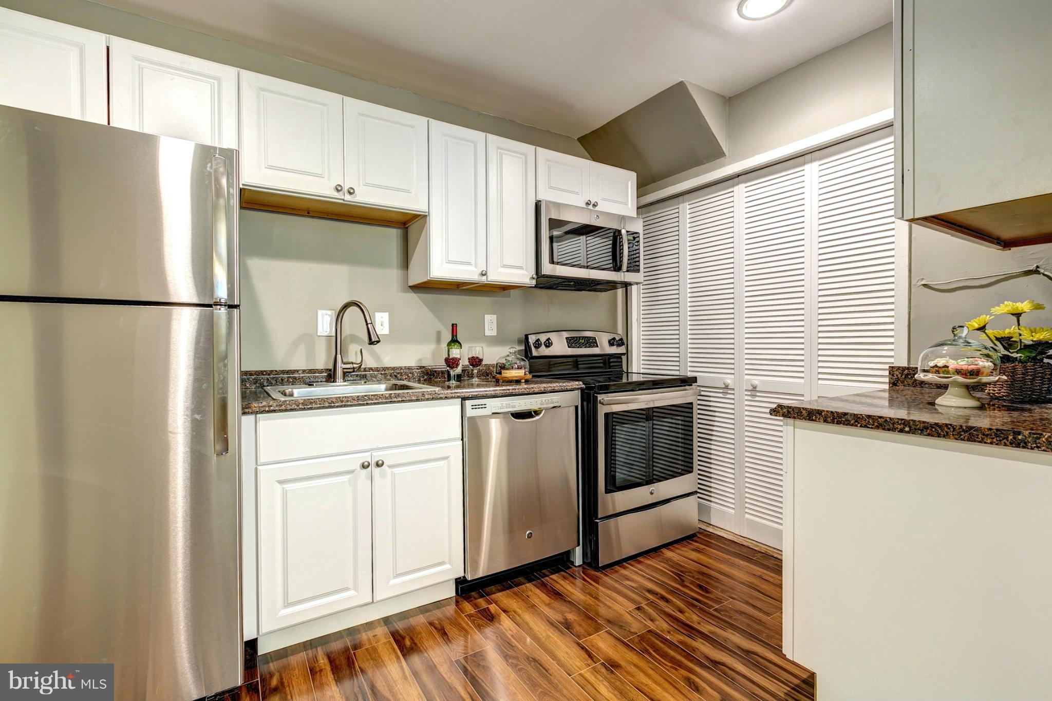 12108 Bluhill Road Silver Spring, MD 20902 - Photo 11 of 30 a kitchen with stainless steel appliances a refrigerator sink and microwave