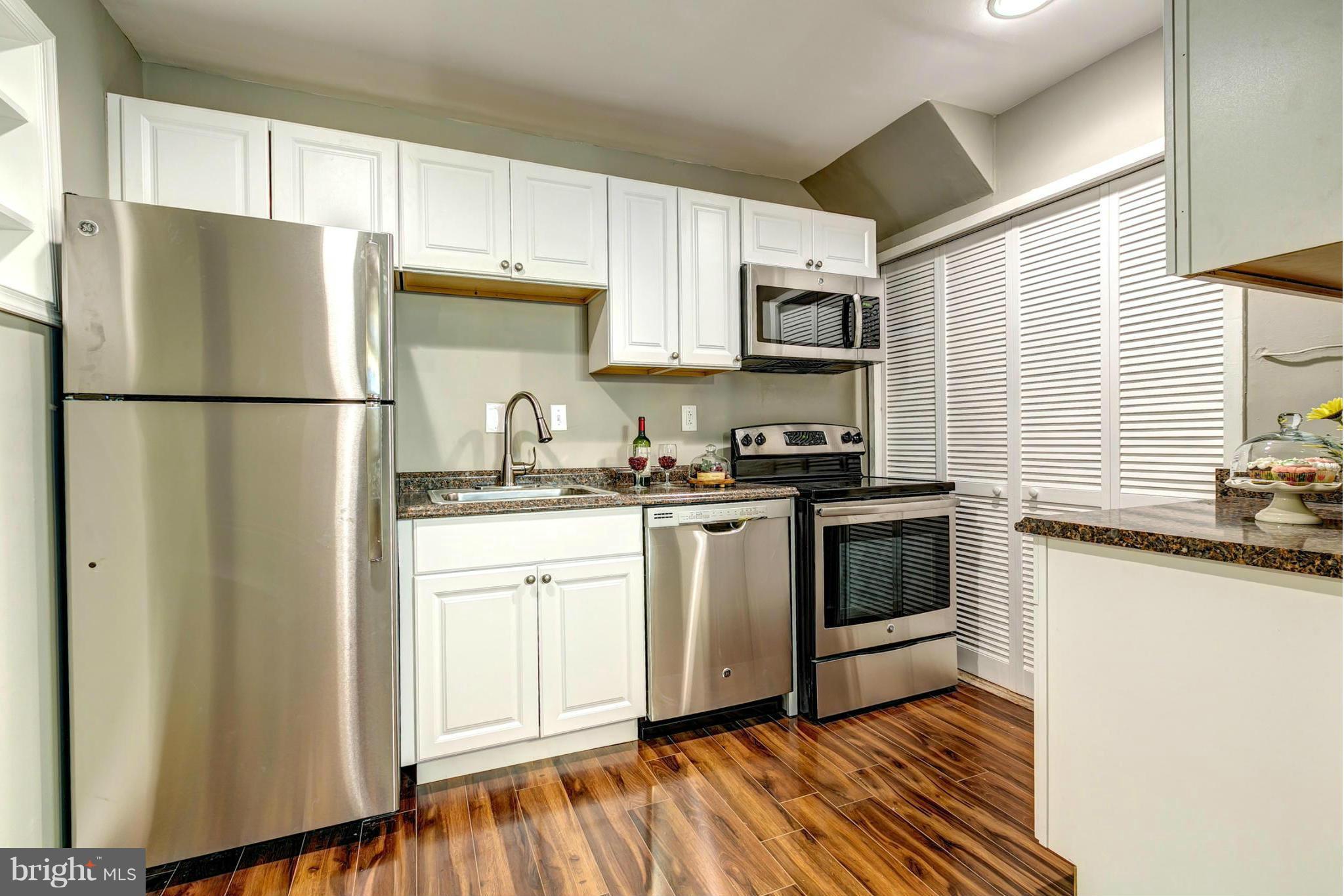 12108 Bluhill Road Silver Spring, MD 20902 - Photo 14 of 30 a kitchen with stainless steel appliances a refrigerator sink and microwave