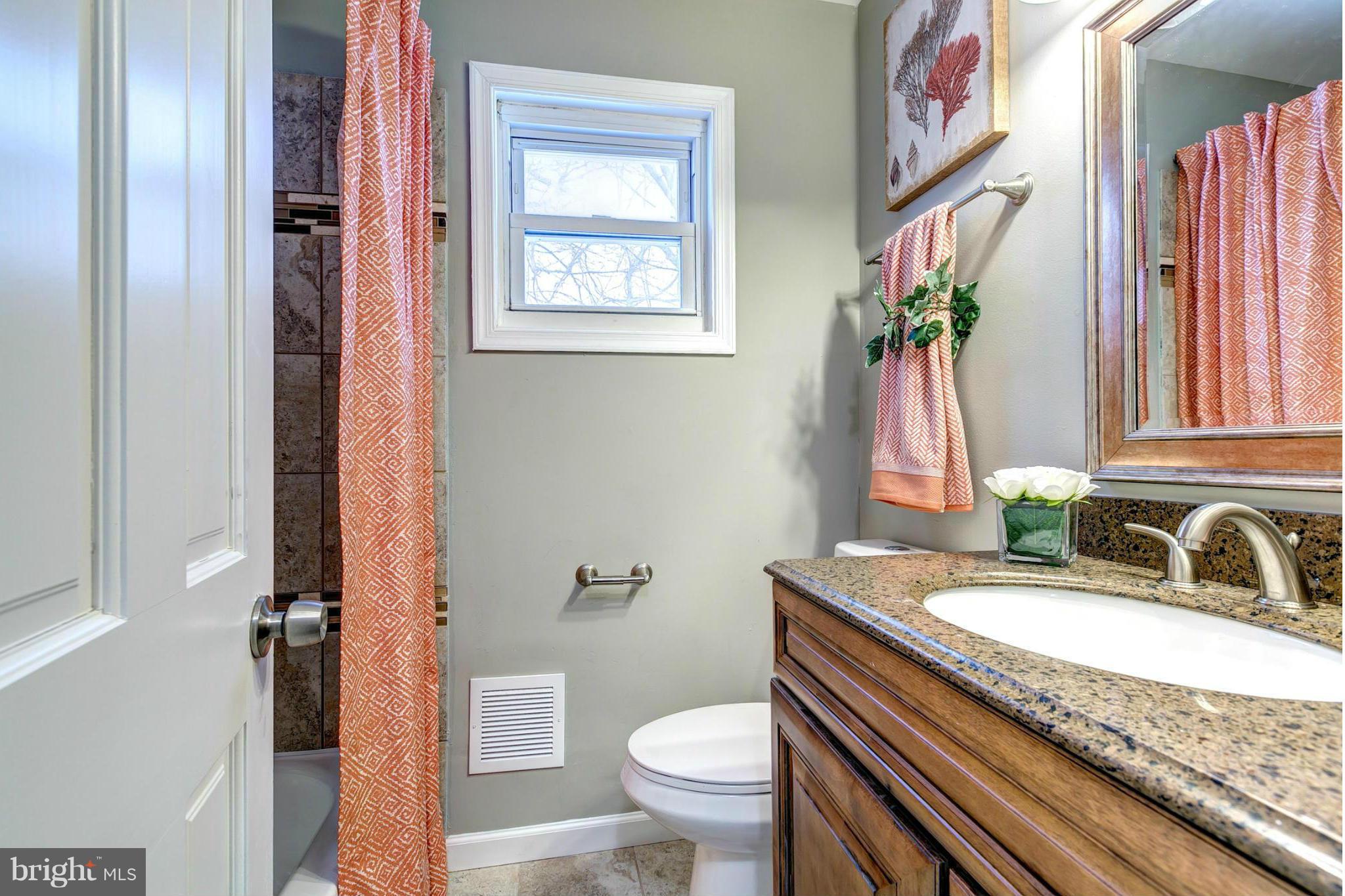 12108 Bluhill Road Silver Spring, MD 20902 - Photo 17 of 30 a bathroom with a granite countertop sink toilet and a mirror