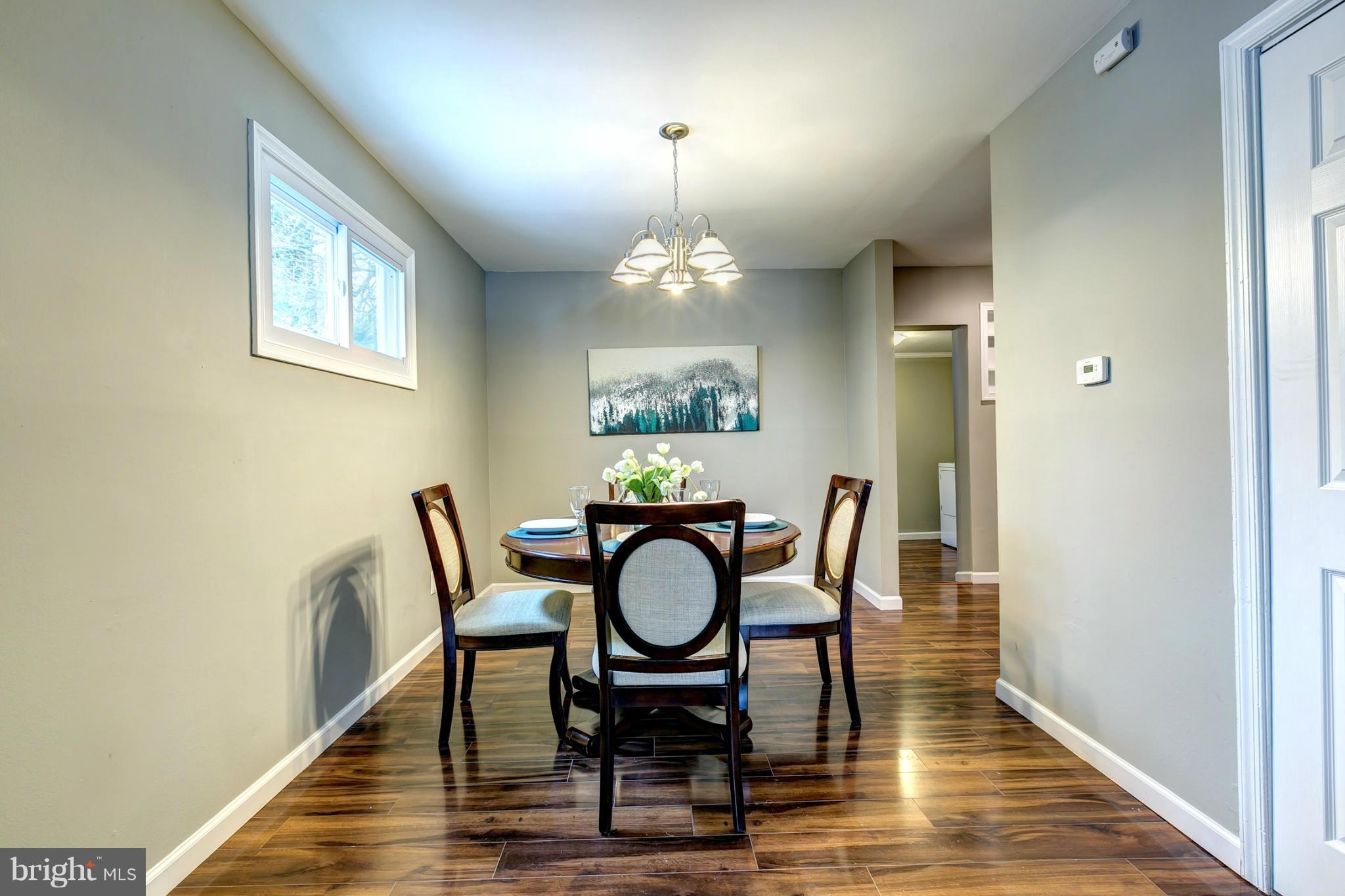 12108 Bluhill Road Silver Spring, MD 20902 - Photo 7 of 30 a view of a dining room with furniture and wooden floor