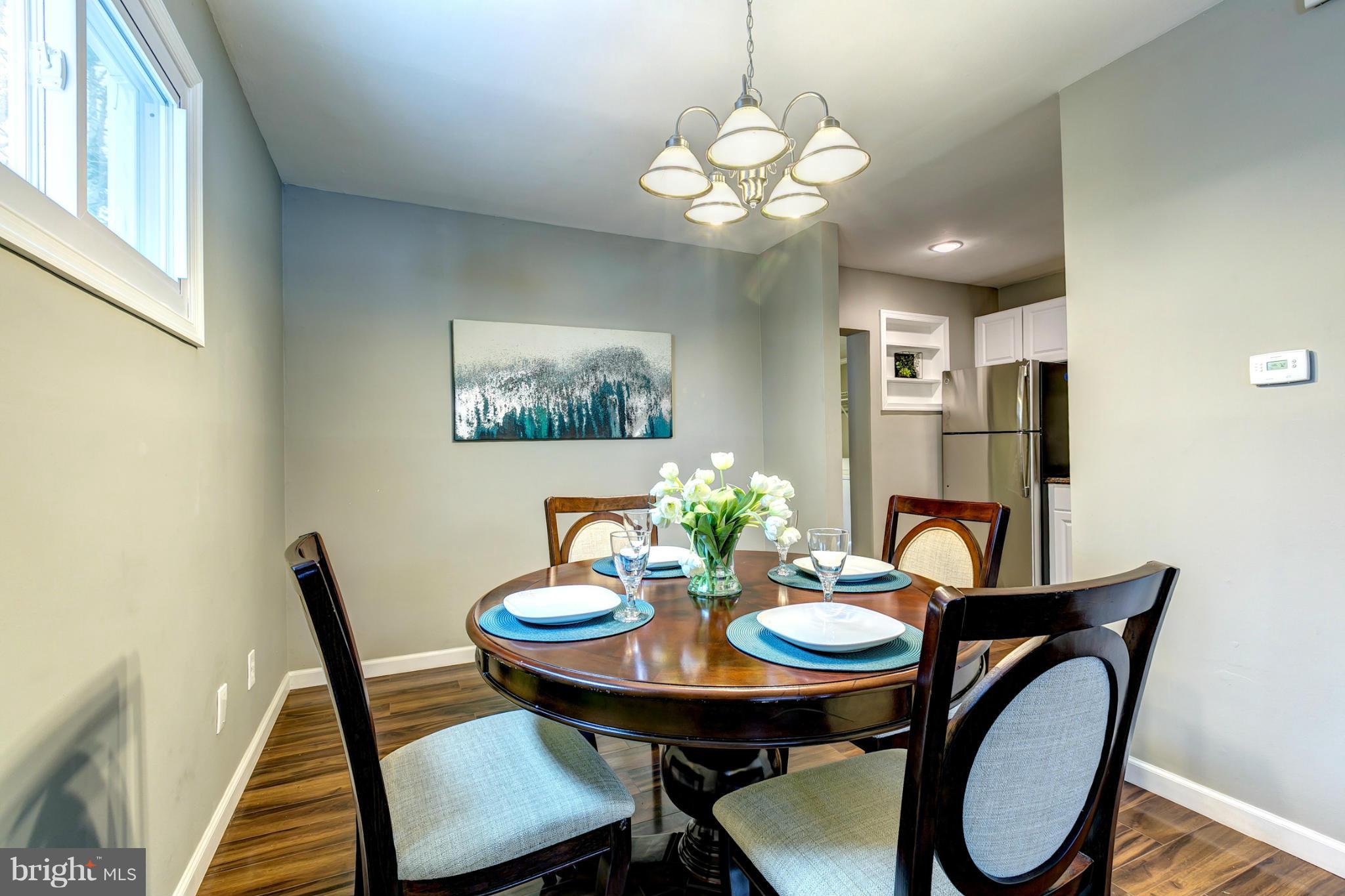 12108 Bluhill Road Silver Spring, MD 20902 - Photo 9 of 30 a view of a dining room with furniture and chandelier
