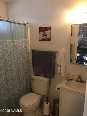 a bathroom with a toilet and a sink