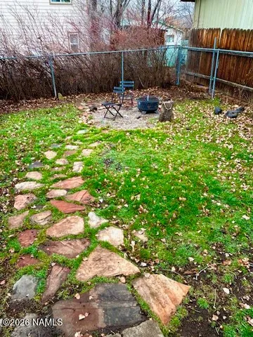 a view of backyard with a table and chairs