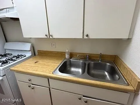 a kitchen with a sink and cabinets
