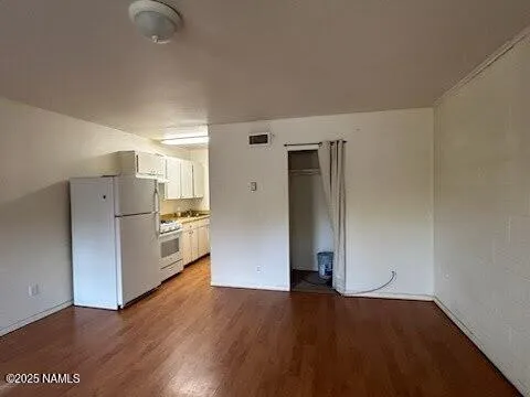 a view of kitchen view wooden floor and electronic appliances