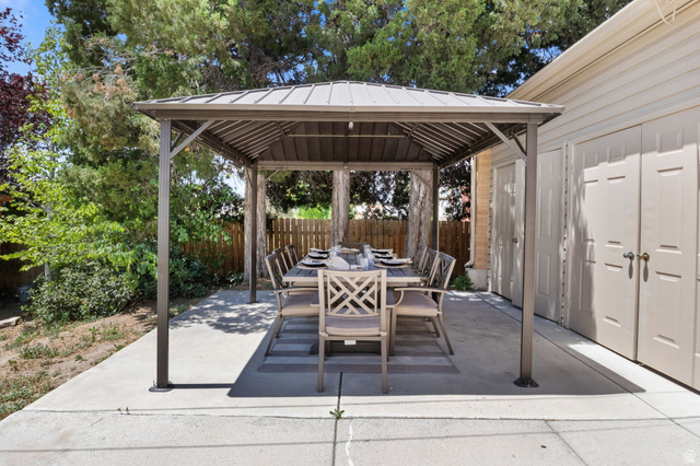 576 East 3950 North Provo, UT 84604 - Photo 46 of 47 Expansive concrete patio with a permanent gazebo structure, offering an outdoor dining area